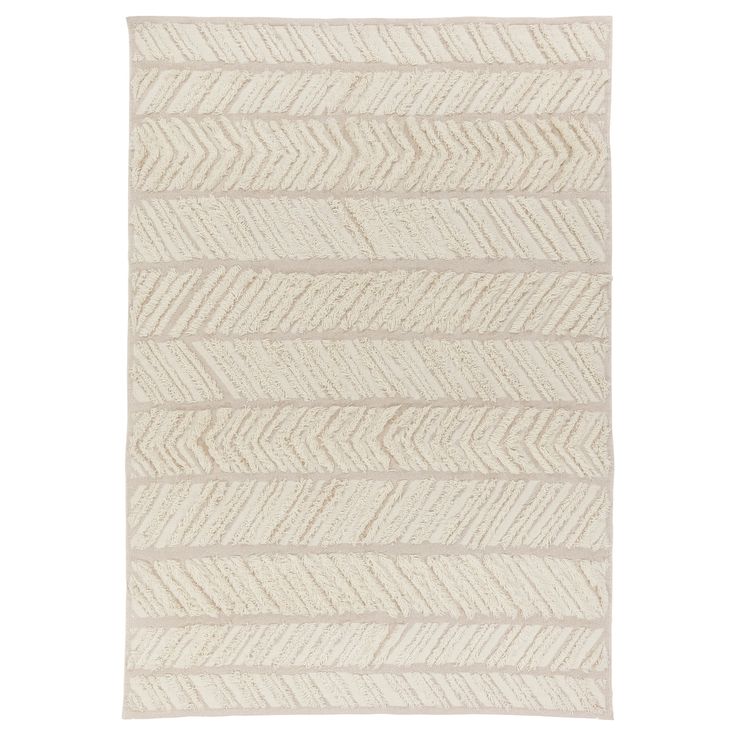 a white rug with an arrow pattern on the front and back of it, in neutral tones