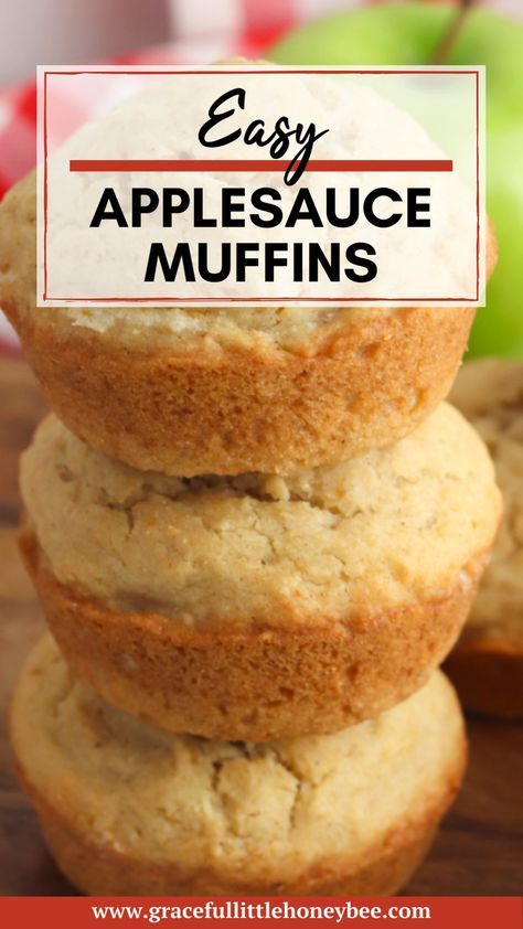 three applesauce muffins stacked on top of each other with an apple in the background