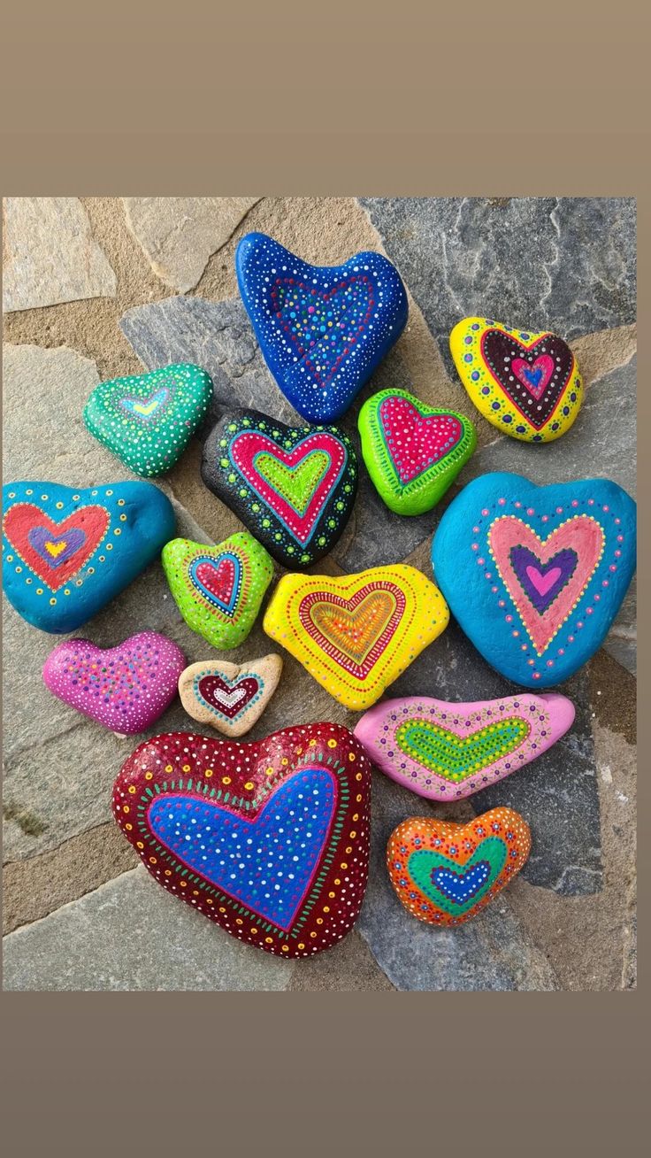 colorful painted rocks arranged in the shape of hearts