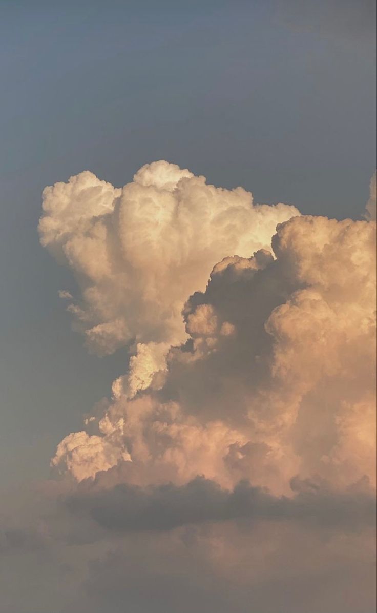 an airplane is flying in the sky with clouds