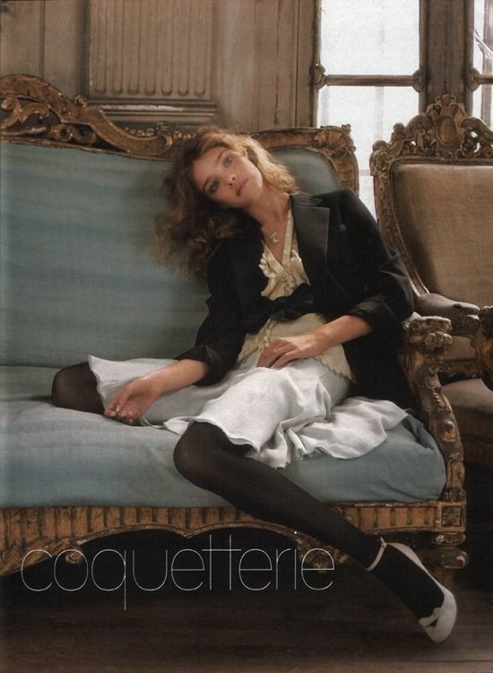 a woman sitting on top of a blue couch