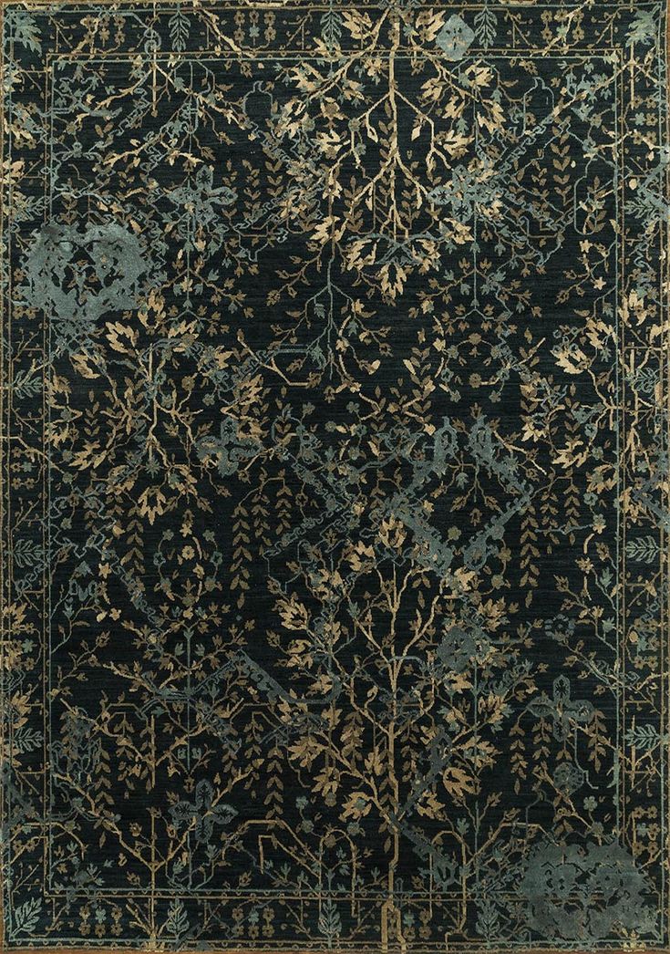 a black rug with gold and blue designs on it's sides, in the middle of