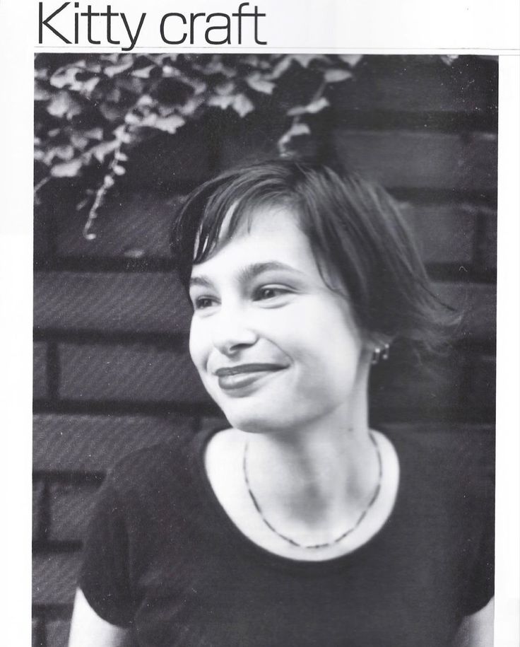 a black and white photo of a woman with a smile on it's face