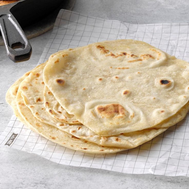 four flat breads are stacked on top of each other