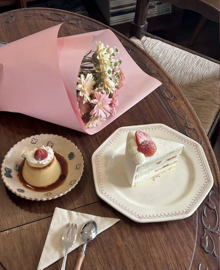 there is a piece of cake on the table next to two plates and a fork