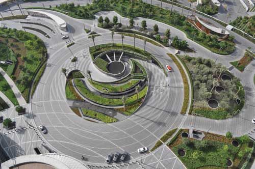 an aerial view of a roundabout in the middle of a city with cars driving around it