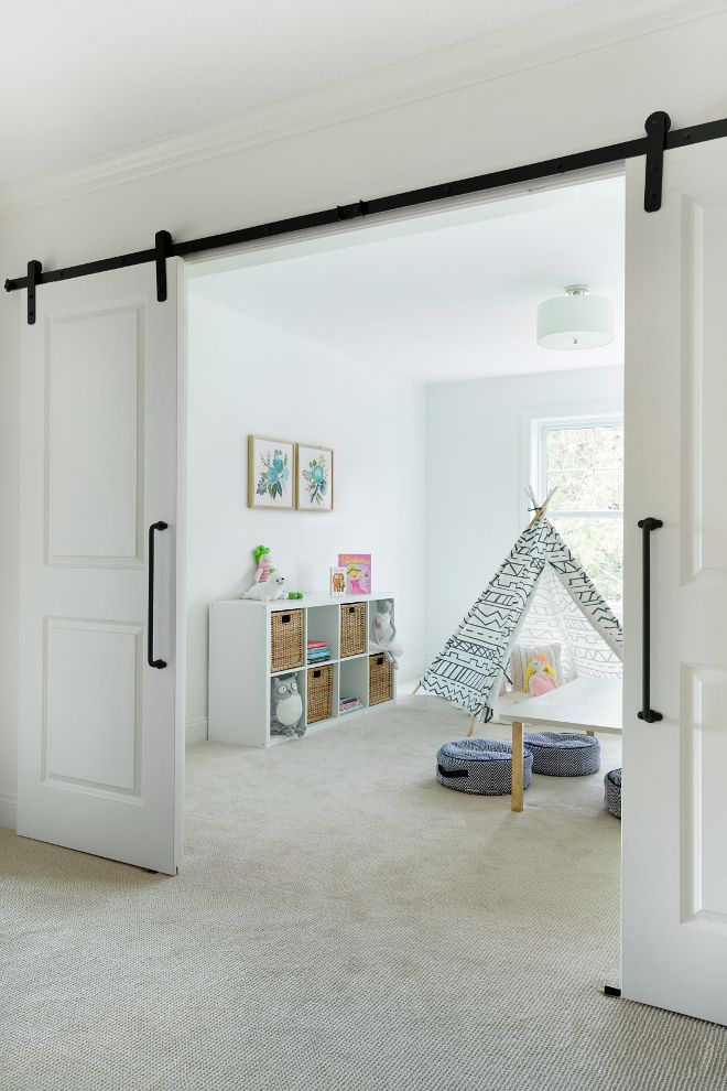 an open door leading to a bedroom with a teepee tent in the corner and toys on the floor