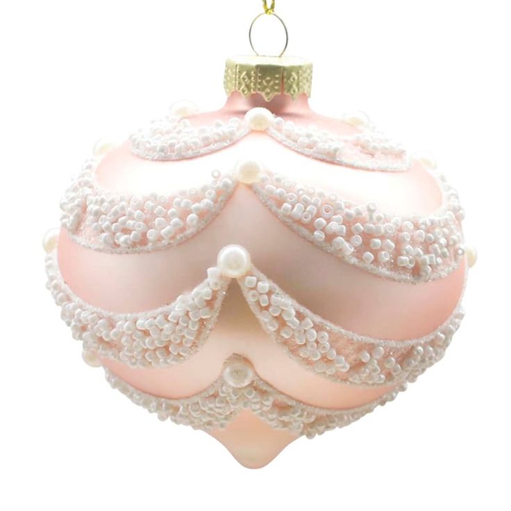 a pink glass ornament with pearls on it