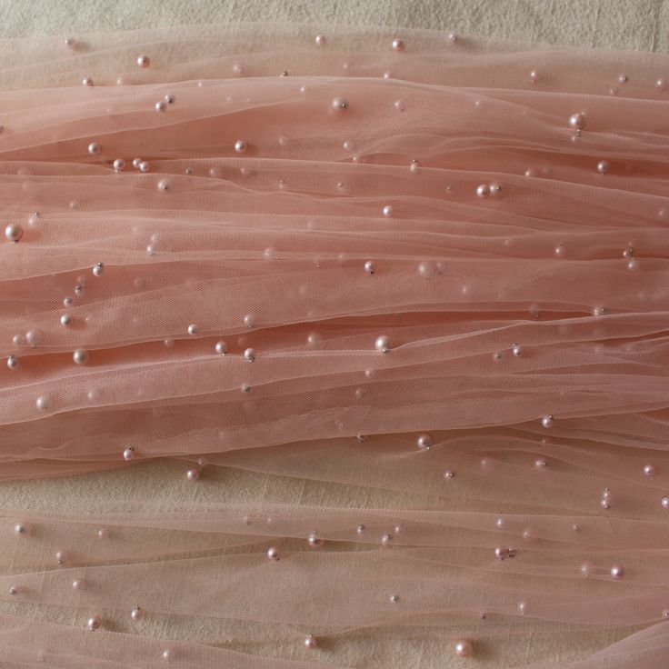 pink tulle with white pearls on it