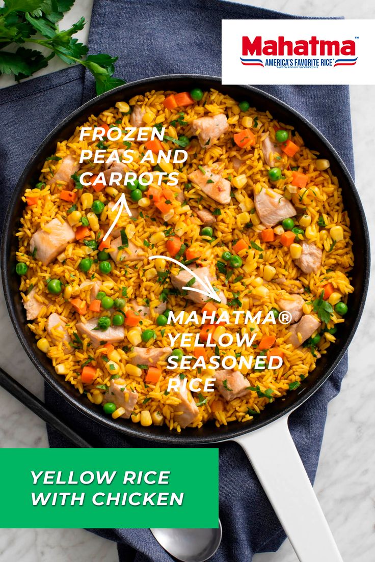 a pan filled with yellow rice and vegetables