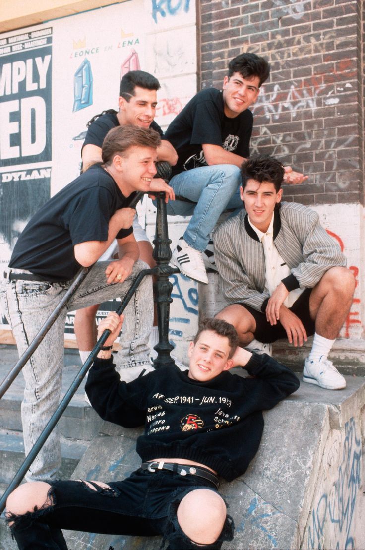 four young men are sitting on the steps