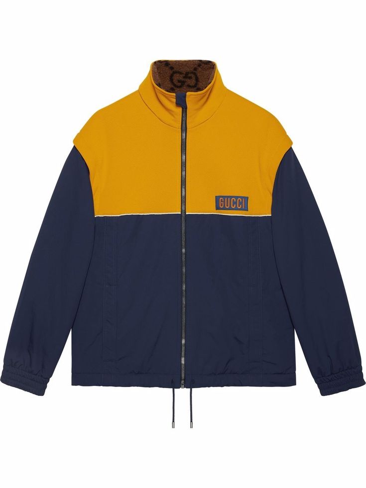 Navy/yellow two-tone Technical jersey jacket from GUCCI featuring two-tone design, appliqué logo, funnel neck, detachable sleeves, front zip fastening and Technical jersey. Luxury Fall Outerwear With Logo Patch, Sporty Gucci Outerwear For Fall, Designer Long Sleeve Outerwear With Logo, Gucci Sporty Outerwear For Streetwear, Gucci Winter Outerwear With Ribbed Cuffs, Designer Winter Outerwear With Logo Detail, Gucci Casual Track Jacket For Winter, Designer Gucci Outerwear With Ribbed Cuffs, Sporty Gucci Outerwear For Streetwear