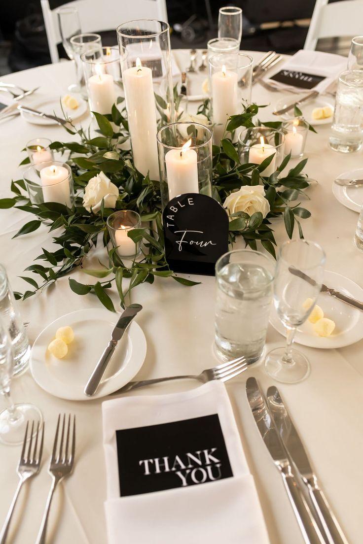 a table set with place settings and candles