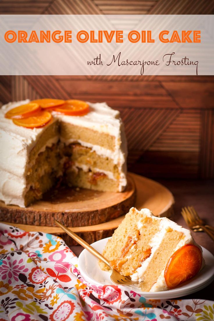 an orange olive oil cake with mascarpone frosting on a plate next to a slice