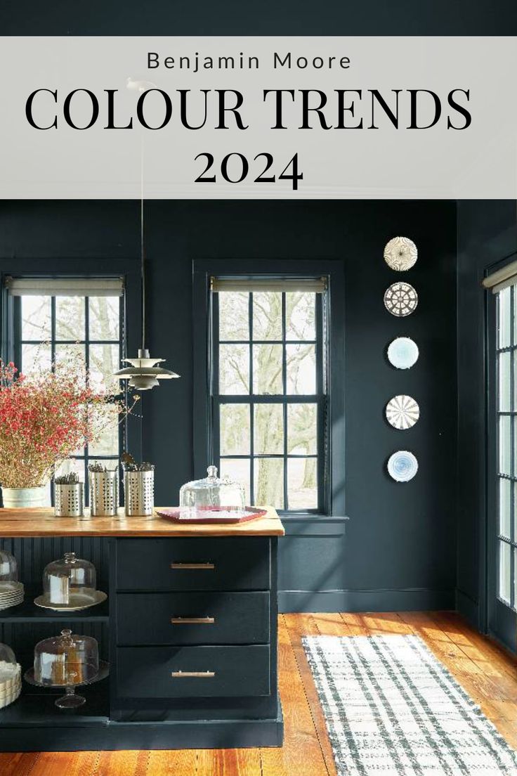 a kitchen with black walls and wooden flooring is featured in the magazine's color trend