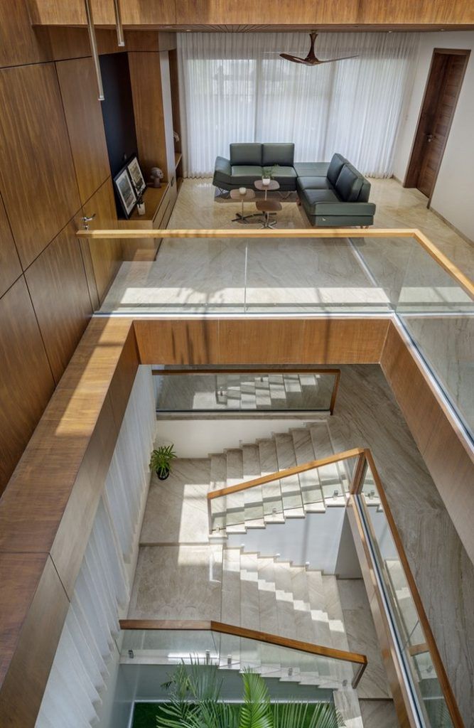 an aerial view of a living room and staircase in a modern house with wood paneling