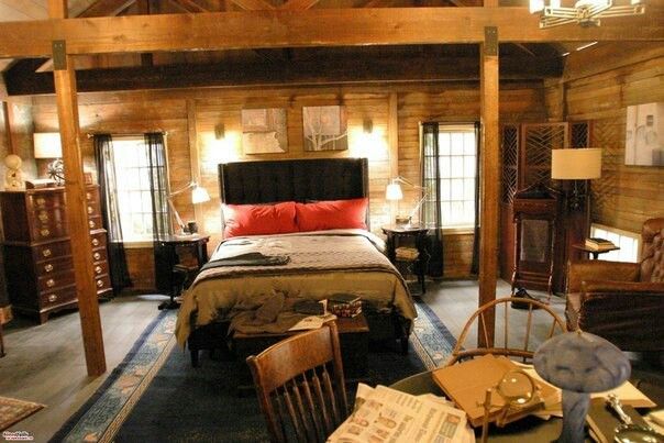 a bed sitting in a bedroom next to a wooden ceiling