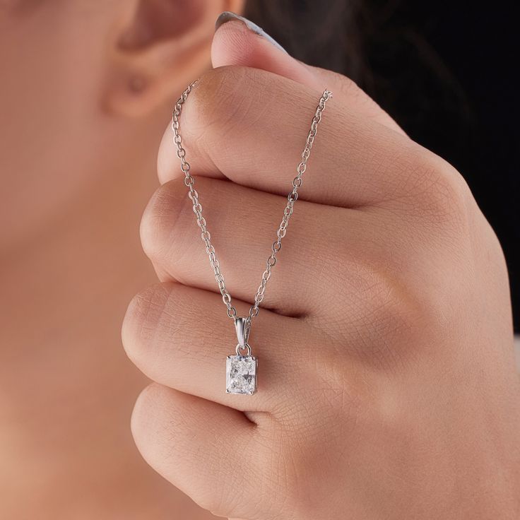 Indulge in the timeless allure of our exquisite Lab Grown Radiant Diamond Pendant. Available in the brilliance of 10k, 14k, or 18k White, Rose, or Yellow Gold, this captivating piece is designed to elevate any occasion. At its heart lies a 1 carat lab grown diamond, boasting F+ color and VS+ clarity. Crafted with meticulous attention to detail and exceptional polish, this pendant exudes a radiant sparkle that will captivate all who behold it. The diamond is securely set in a classic four-prong s Emerald Cut Solitaire Necklace With Diamond Accents, Radiant Cut Solitaire Necklace For Formal Occasions, Elegant Radiant Cut Solitaire Necklace For Anniversary, Emerald Cut Solitaire Necklace For Formal Occasions, Elegant Gia Certified Wedding Necklaces, White Gold Solitaire Necklace With Emerald Cut, Elegant Baguette Cut Solitaire Necklace With Prong Setting, White Gold Emerald Cut Solitaire Necklace, Elegant Emerald Cut Solitaire Necklace For Wedding