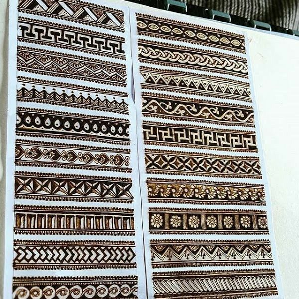 two pieces of brown and white paper with designs on them