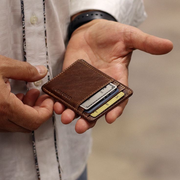 HAND-STAINED BUFFALO LEATHER When a few cards and a photo ID are all that you really need to carry, this slim leather wallet is the perfect companion. Made from hand stained buffalo leather that grows in character and beauty as it ages, this small Voyager Wallet features rounded corners to resist breakage, RFID protection, and three card slots to hold your credit card, bank card, and a membership card. The ID window is perfect for your driver's license, school, or work ID. This hand made leather Blue Leather Wallet, Slim Wallet Men, Minimalist Leather Wallet, Wallets For Men, Leather Ideas, Slim Leather Wallet, Leather Passport Holder, Leather Card Wallet, Membership Card