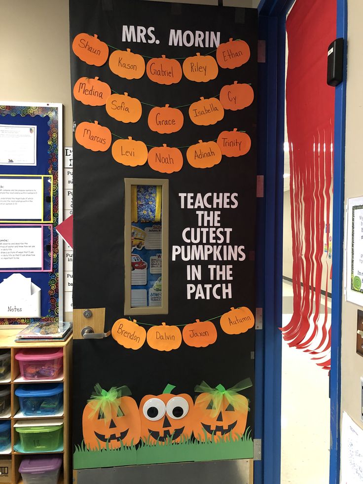 a classroom door decorated for halloween with pumpkins