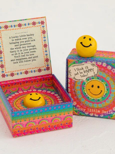 two small boxes with smiley faces on them and a card in the box that says, i think they are happy