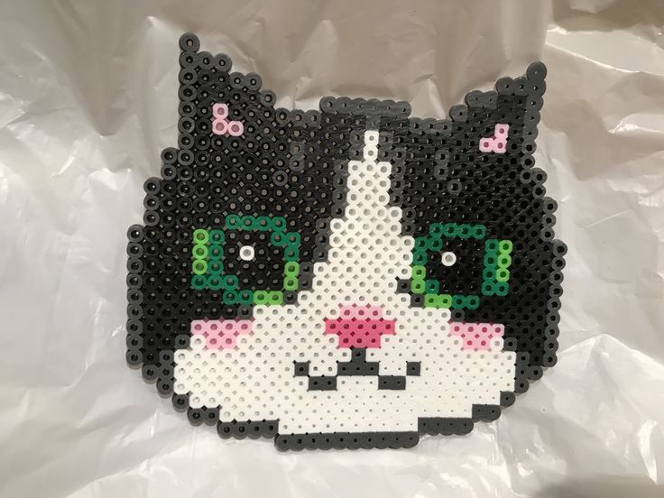 a black and white cat made out of plastic beads