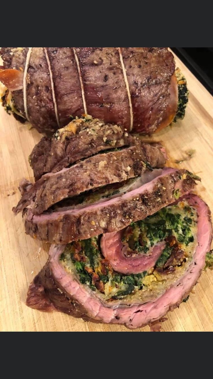 sliced meat and vegetables on a cutting board