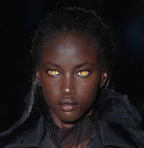 a model with yellow eyes and black hair