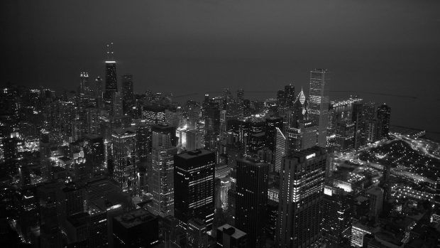 black and white photo of the city at night from top of skyscrapers in new york