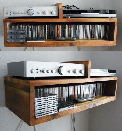 two wooden shelves holding various audio and video equipment