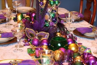 the table is set with purple, green and gold decorations for mardi gras