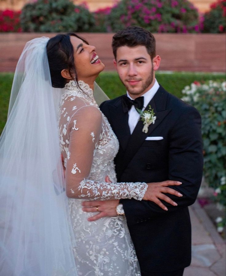 the bride and groom are posing for a photo