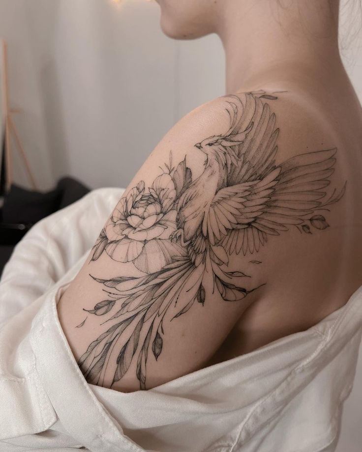 a woman with a bird tattoo on her shoulder