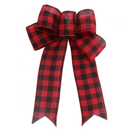 a red and black plaid bow with a long ribbon on the front, attached to a white background