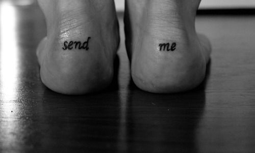 two feet with the words send me tattooed on them