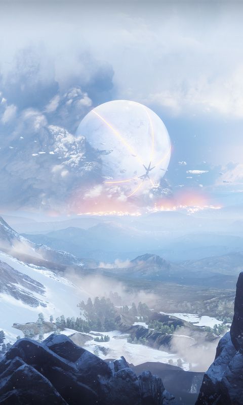 a man standing on top of a snow covered mountain next to a giant alien like object