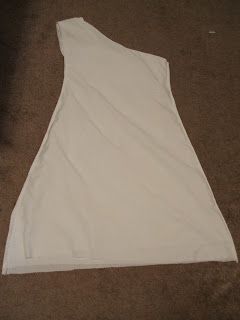 a white dress is laying on the floor