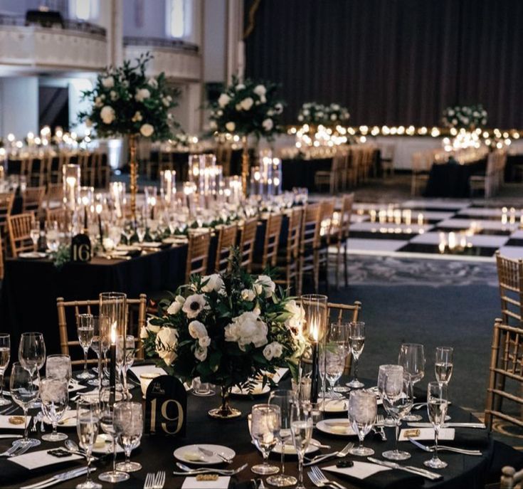 the tables are set up with candles and centerpieces for an elegant wedding reception