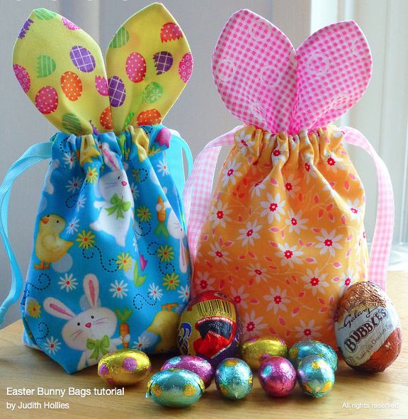 three bags filled with easter eggs on top of a table