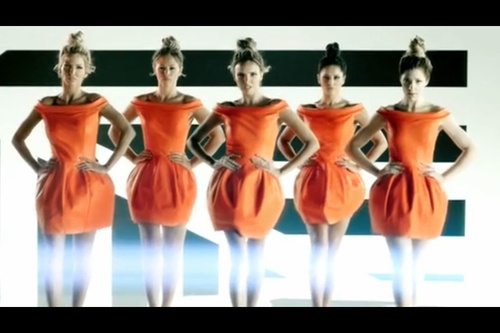 the models are posing in orange dresses