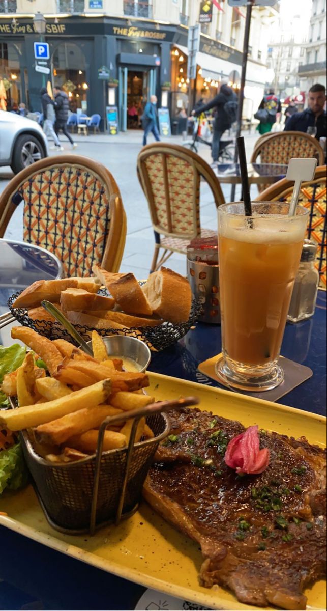 steak and french fries are on a yellow plate