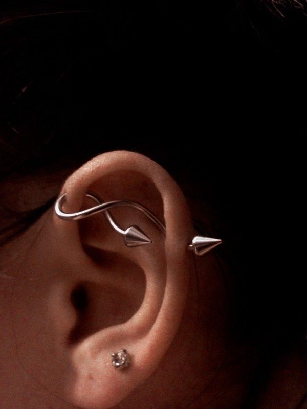 an ear with two different types of piercings on it