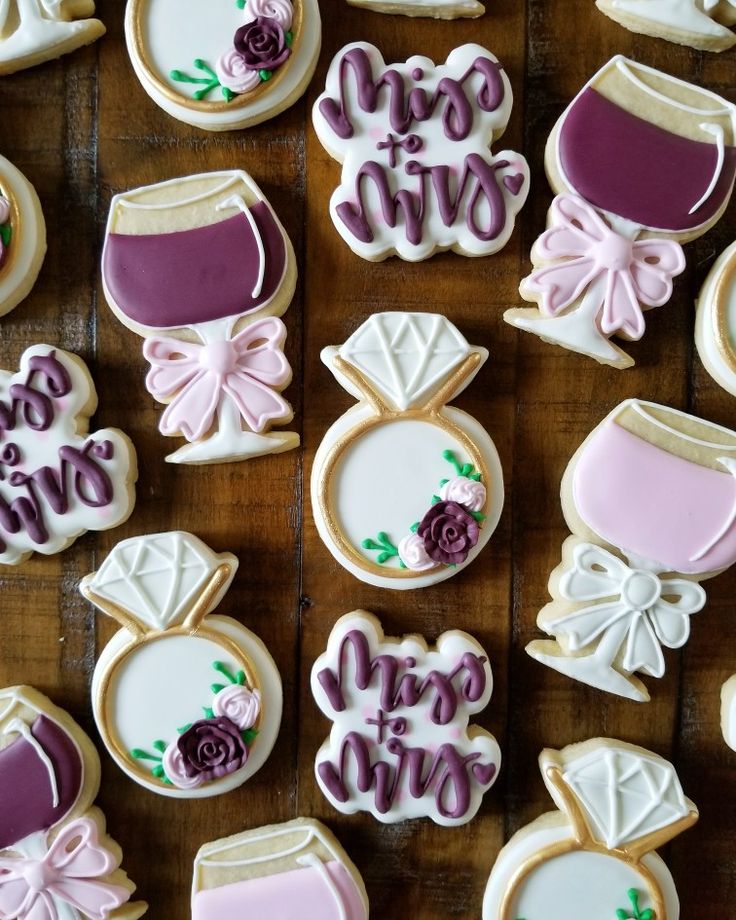 decorated cookies are arranged on a wooden table