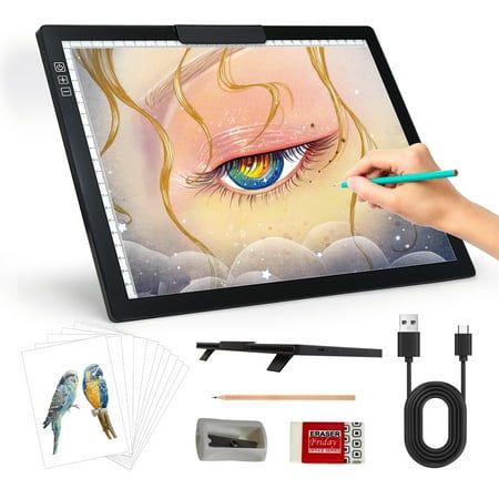 a person drawing on a tablet with pencils and other items surrounding the device, including an image of a woman's face