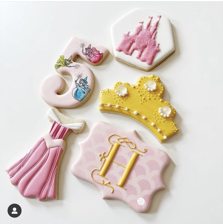 decorated cookies are arranged in the shape of princess's tiara and dress - ups