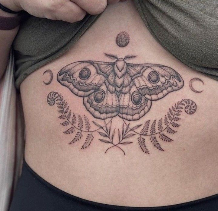 a woman with a butterfly tattoo on her stomach