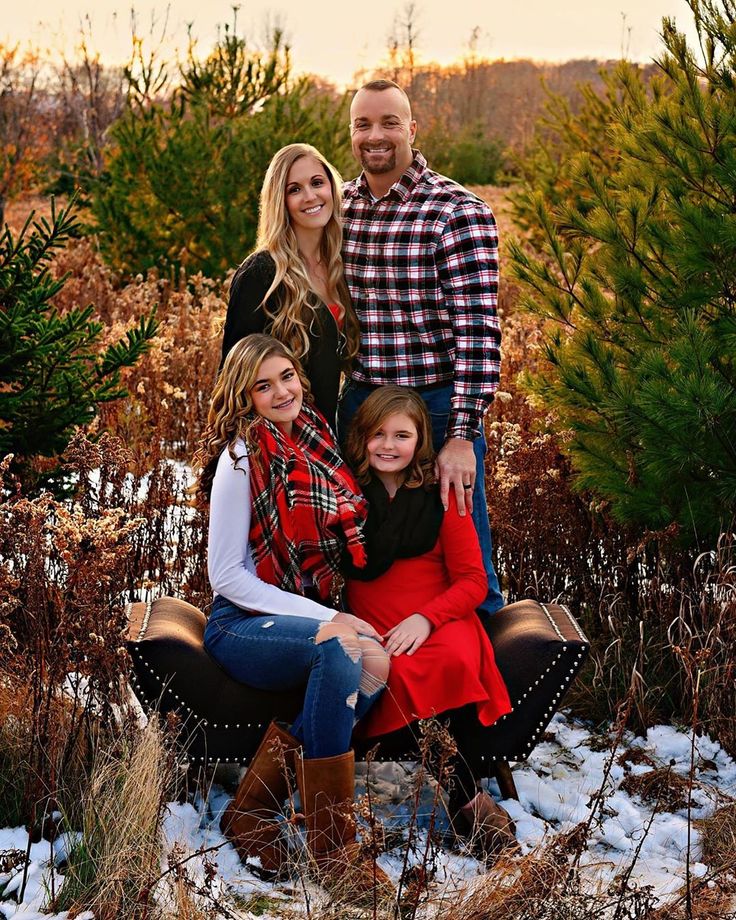 a family posing for a photo in the snow