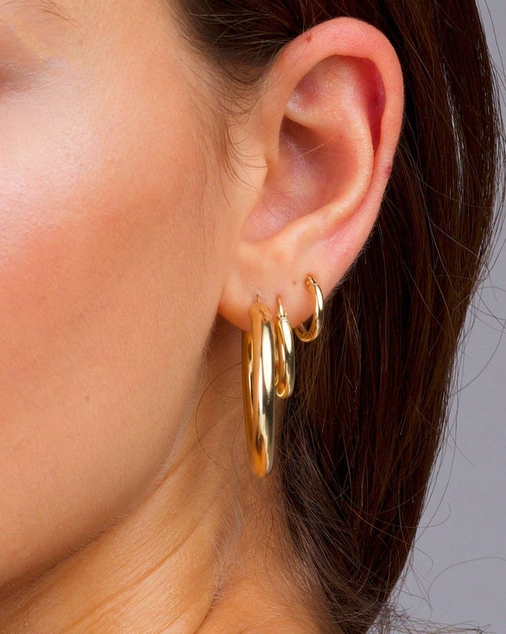 "These stacking earrings in Gold are to die for, stack em' up or wear them by themselves. The second photo shows a size guide for you. They are classic yet have that modern feel. These earrings will be your new favorites! Buy them individually or buy them all for the look in the images! xx DETAILS: All hoops are sold in pairs. Tiny Hoops Diameter: 12mm Width: 2mm Medium Hoops Diameter: 13mm Width: 3mm Classic Hoops Diameter: 25mm Width: 4mm QUALITY: * 100% 14k Gold Vermeil or Sterling Silver ava Hoop Earring Outfit, Blush Jewelry, Thick Gold Hoops, Modern Hoop Earrings, Earrings Stacking, Thick Hoop Earrings, 14k Gold Hoop Earrings, Medium Hoop Earrings, African Earrings