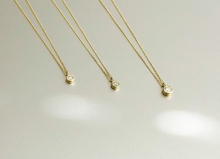 DETAILS * We never use gold plates or gold-filled metals in any of our jewelry. All the metals we use are lead-free, nickel-free, and hypoallergenic. * Pendant Width: 2.5 mm * Pendant Height: 2.5 mm * Chain Length: 18 inches * Chain Type: Dainty Cable * Clasp: Spring Ring * Ready to Ship in 1-3 Business Days * 100% US sourced * 6 Months Warranty * Free returns within 30 days from the order date DIAMOND DETAILS * Gem Stone: Genuine Diamond * Diamond-Cut: Round * Number of Stones: 1 * Diamond Cara Gold Birthstone Necklace With Bezel Setting, Gold Round Cut Birthstone Necklace For Everyday, Everyday Gold Birthstone Necklace With Bezel Setting, Gold Solitaire Necklace With Round Cut Birthstone, Everyday Gold Birthstone Necklace With Round Cut, Gold Necklace With Bezel Setting, Everyday Gold Solitaire Necklace With Single Diamond, Gold Birthstone Necklace With Single Diamond For Everyday, Everyday Gold Necklace With Bezel Setting